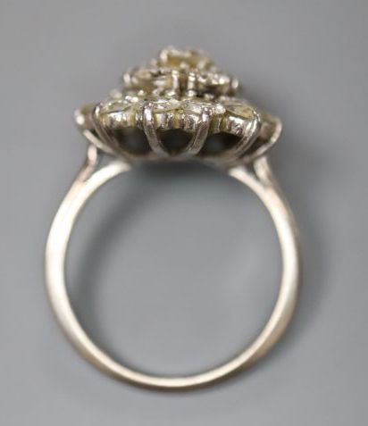 A white metal (stamped 18ct) and domed diamond cluster ring, size J, gross 4.7 grams.